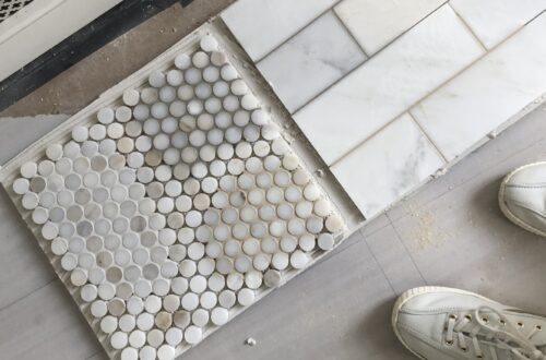 penny and subway marble tiles on floor with varying grout colors applied as samples