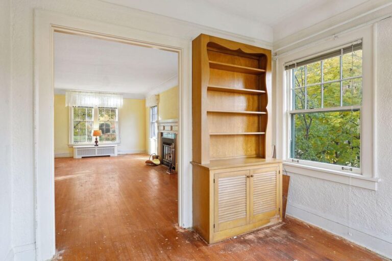 View from inside small den with hutch into long living room