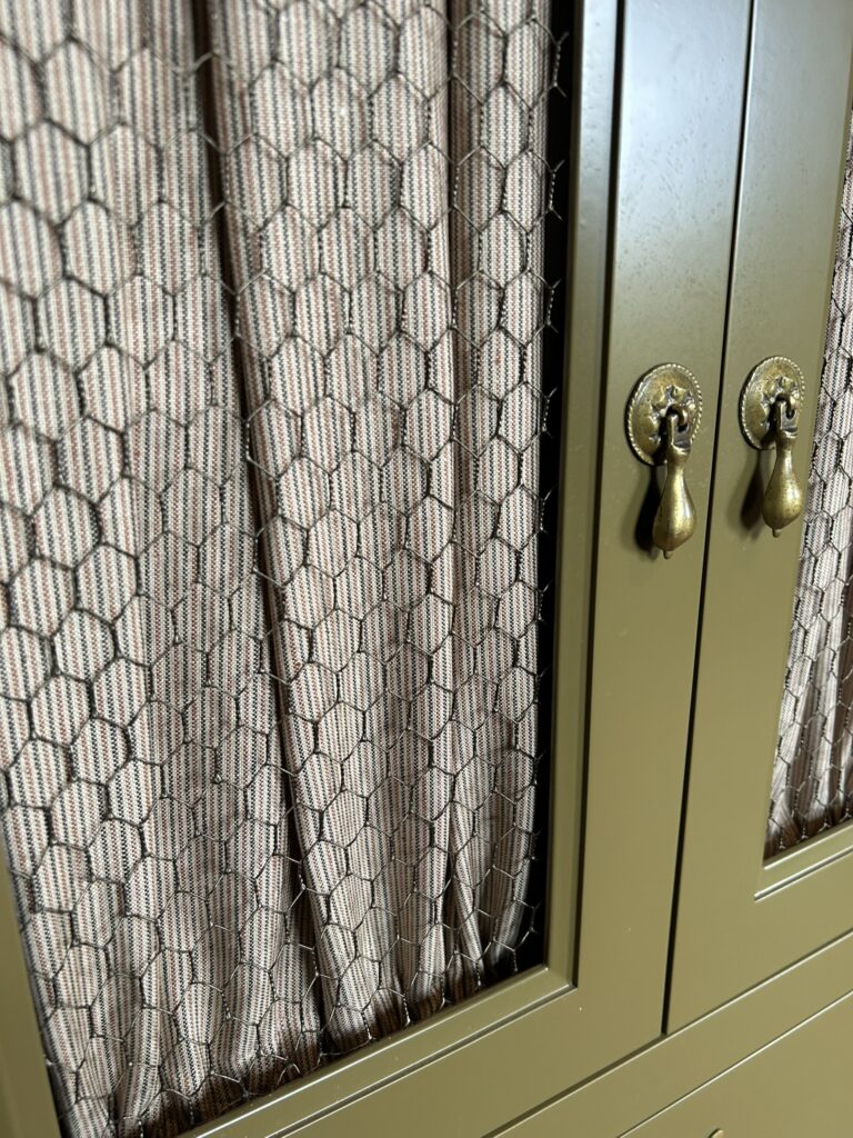 china cabinet with chicken wire and curtains