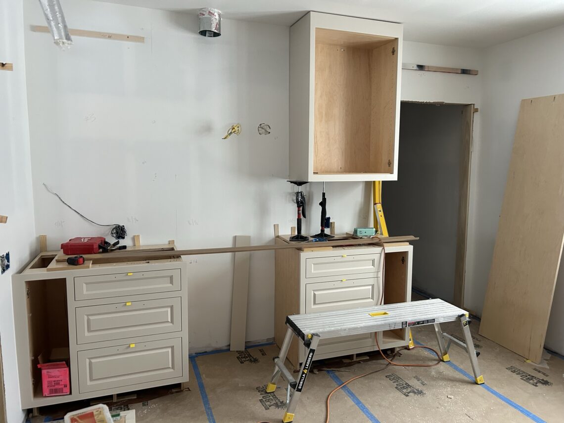 kitchen renovation in progress cabinets being installed