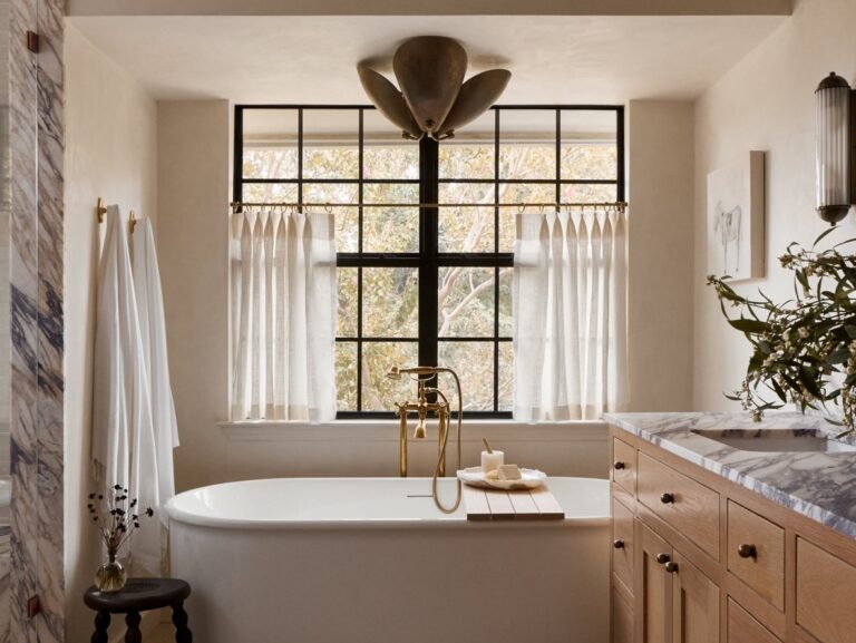 primary bathroom by bide studio focusing on tub and windows