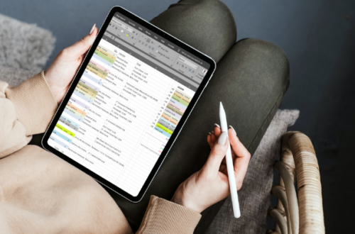 tablet with spreadsheet on woman's lap