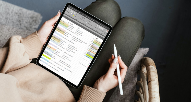 tablet with spreadsheet on woman's lap