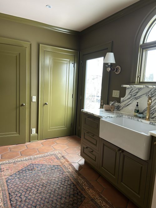 Hillcrest back of house area transformed into a mudroom wih green painted walls/cabinetry and sink with marble splash